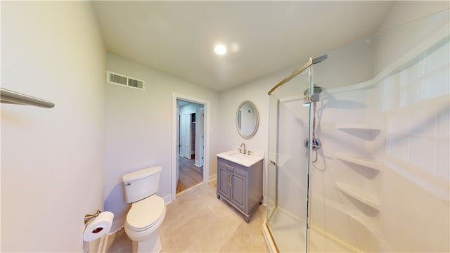 bathroom with vanity, toilet, and an enclosed shower