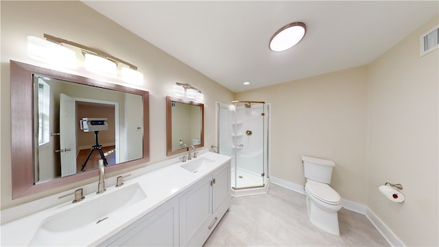 bathroom with a shower with shower door, vanity, and toilet