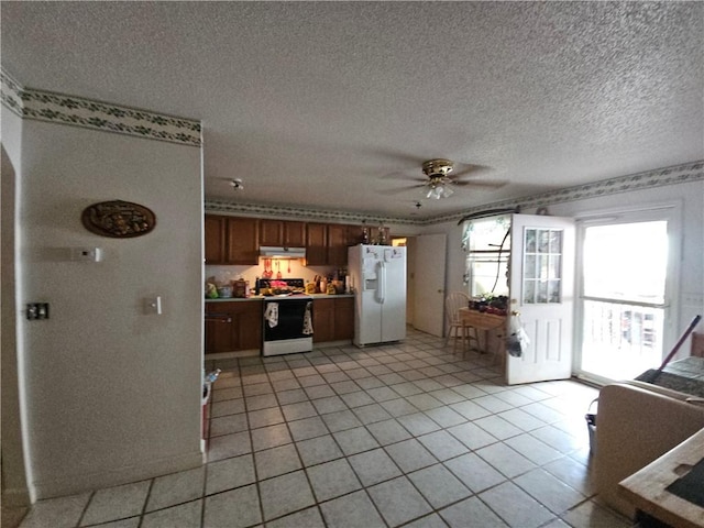 kitchen featuring ceiling fan, range with electric cooktop, white refrigerator with ice dispenser, a textured ceiling, and light tile patterned floors