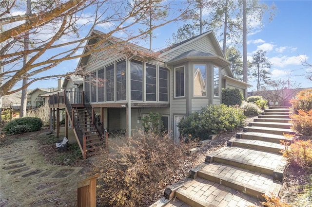 rear view of property with a sunroom