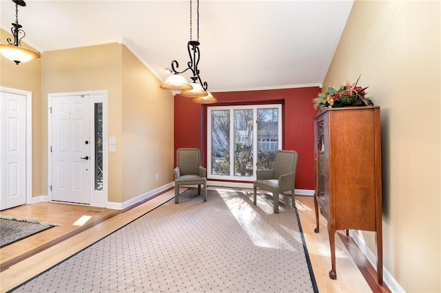 living area with light wood-type flooring and ornamental molding