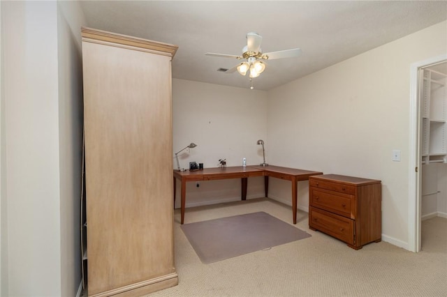 unfurnished office featuring ceiling fan and light colored carpet