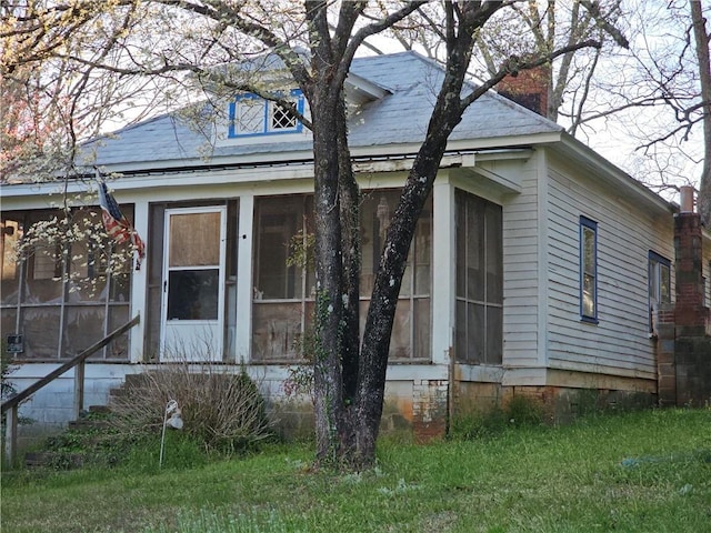 view of front of home featuring a sunroom