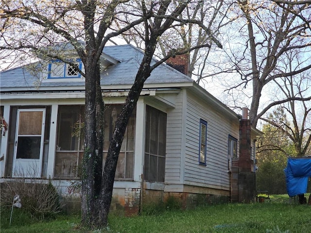 view of side of property with a sunroom