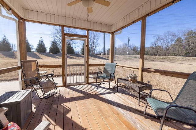 sunroom featuring ceiling fan