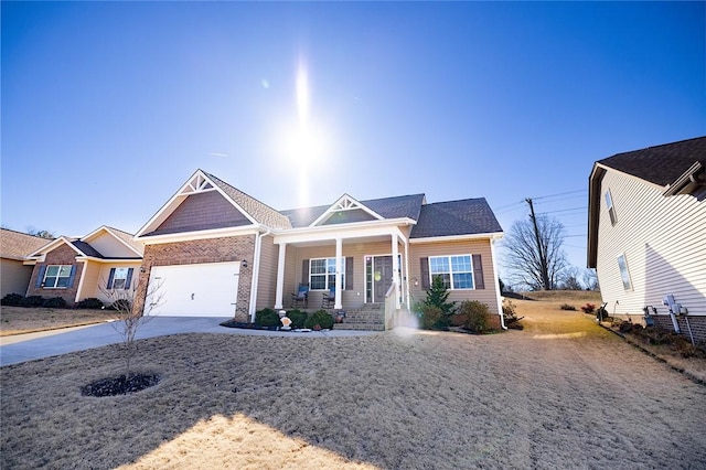 view of front of home featuring a porch, driveway, and a garage