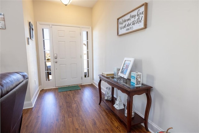 entryway featuring baseboards and wood finished floors