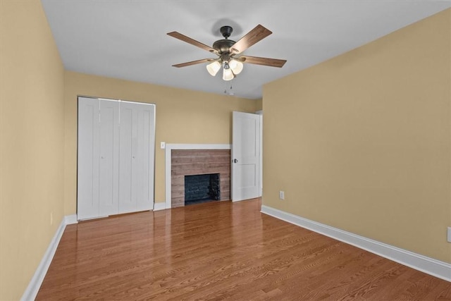 unfurnished living room featuring ceiling fan and hardwood / wood-style floors