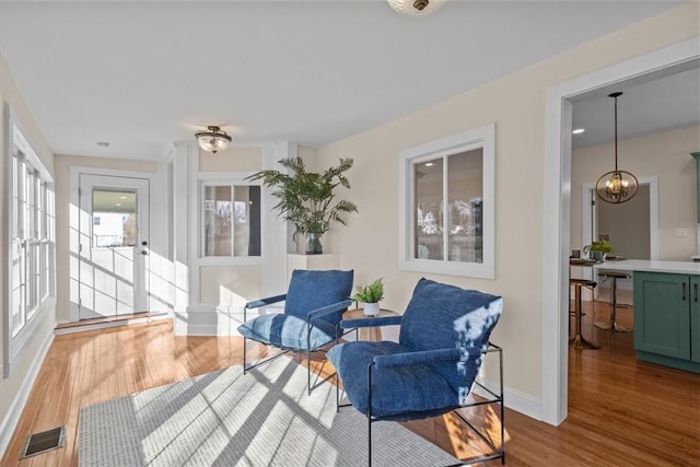 sunroom featuring a chandelier