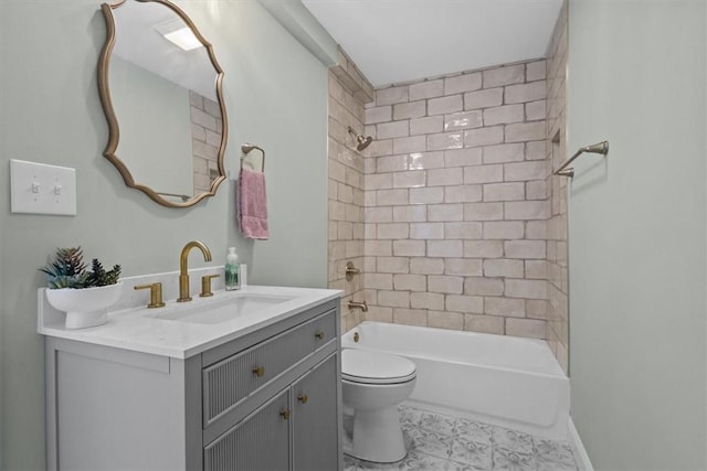 full bathroom with toilet, vanity, and tiled shower / bath