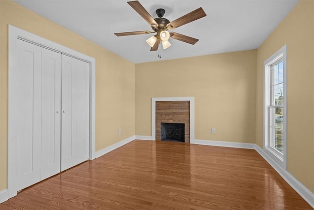 unfurnished living room with ceiling fan and wood-type flooring