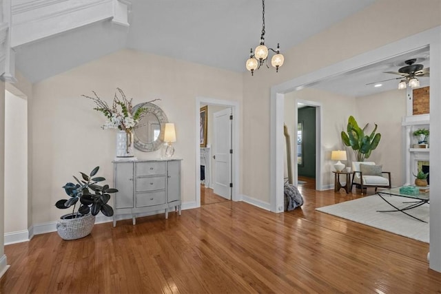 interior space with hardwood / wood-style flooring and ceiling fan with notable chandelier