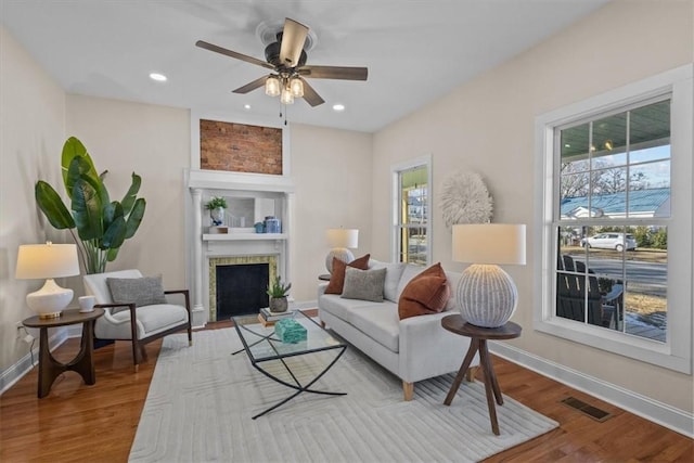 living room with ceiling fan, a healthy amount of sunlight, and wood-type flooring