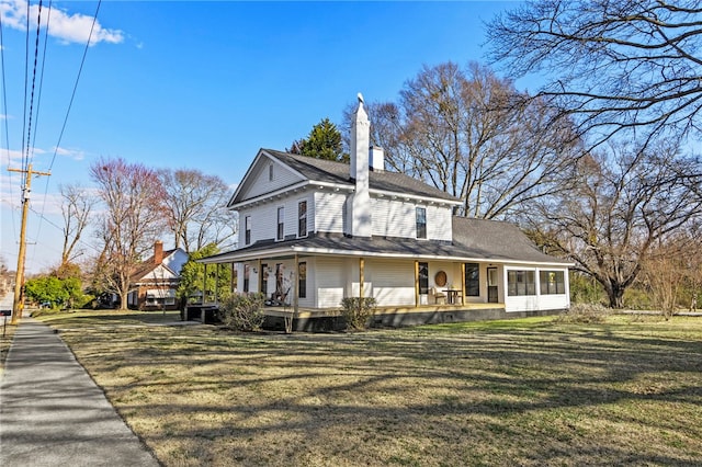 view of property exterior featuring covered porch, a chimney, and a yard