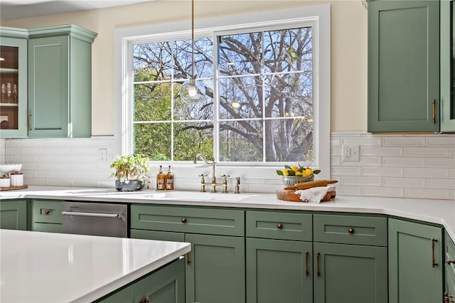 kitchen with light countertops, glass insert cabinets, and green cabinetry