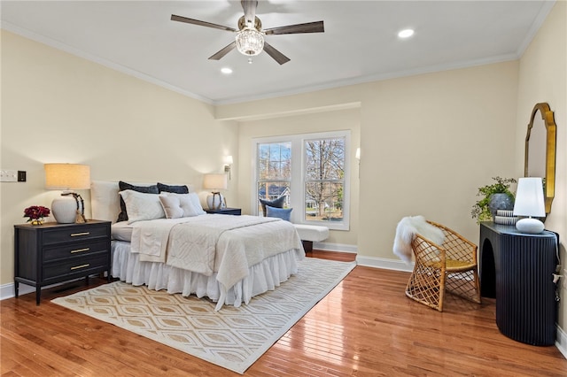 bedroom featuring recessed lighting, baseboards, crown molding, and wood finished floors