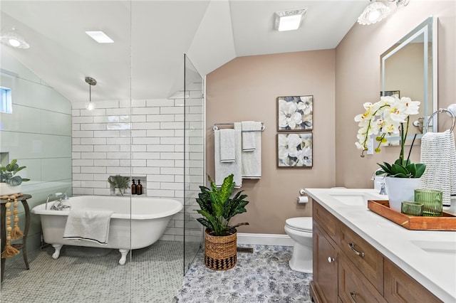 full bathroom featuring a freestanding tub, toilet, tile walls, vaulted ceiling, and double vanity