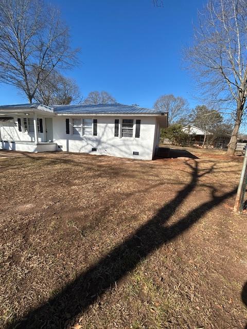 rear view of house featuring covered porch