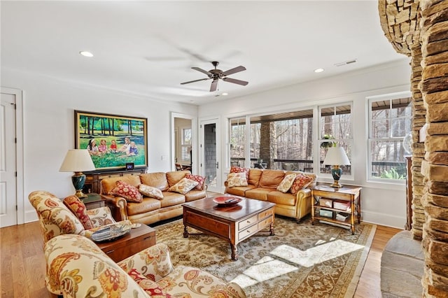 living room with ceiling fan and light hardwood / wood-style flooring