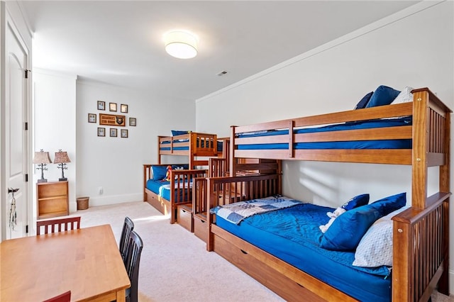 bedroom with crown molding and light colored carpet