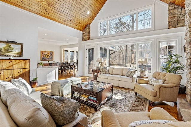 living room with high vaulted ceiling, a healthy amount of sunlight, hardwood / wood-style flooring, and wooden ceiling