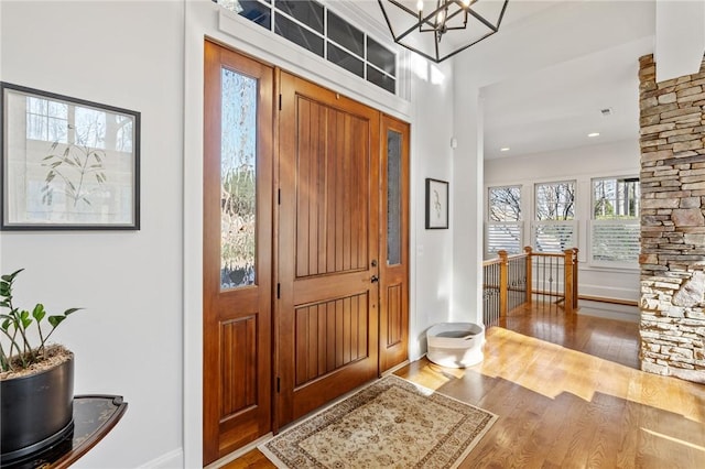 foyer featuring hardwood / wood-style flooring and an inviting chandelier