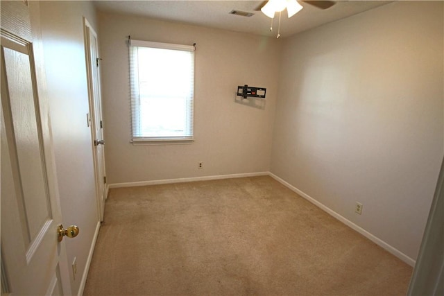 spare room with light carpet and ceiling fan