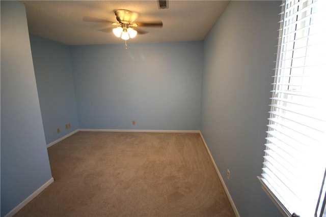 empty room featuring carpet floors and ceiling fan