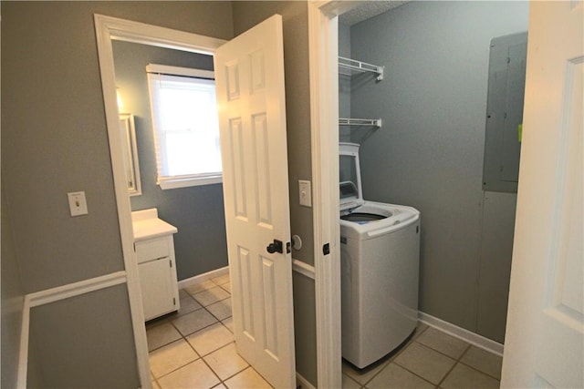 laundry room featuring washer / dryer, electric panel, and light tile patterned flooring