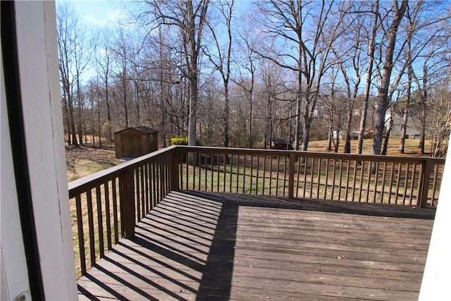 wooden deck featuring a storage unit