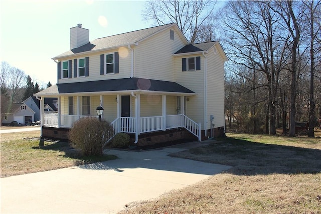 view of front of property with covered porch and a front lawn