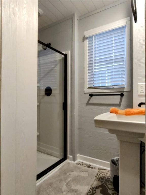 bathroom with a shower with door