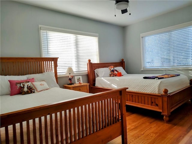 bedroom with wood-type flooring and ceiling fan