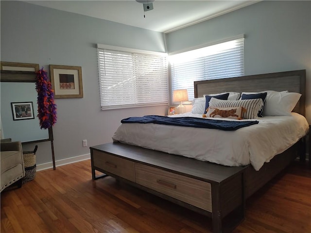 bedroom with dark hardwood / wood-style flooring