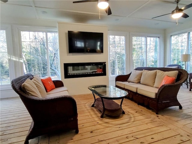 sunroom / solarium featuring ceiling fan and plenty of natural light