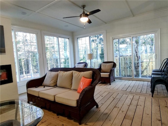 sunroom / solarium featuring ceiling fan