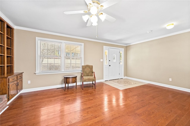 unfurnished room with light hardwood / wood-style floors, ornamental molding, and ceiling fan