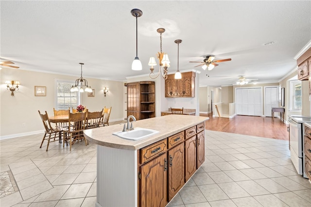 kitchen featuring decorative light fixtures, a kitchen island with sink, ornamental molding, white range with electric cooktop, and sink