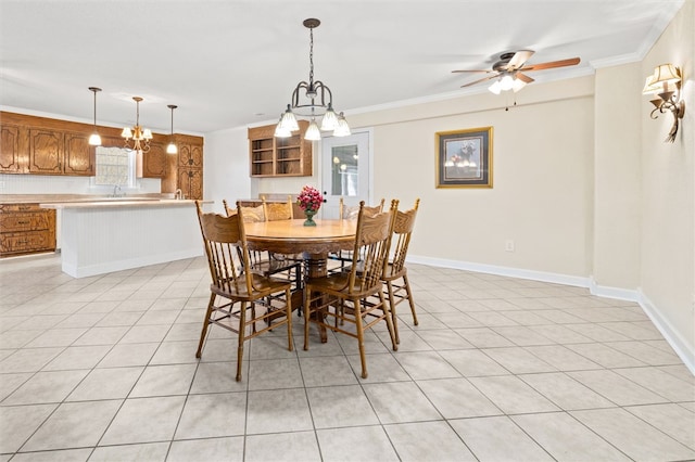 dining room featuring ceiling fan with notable chandelier, sink, light tile patterned floors, and crown molding