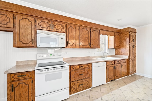 kitchen featuring light tile patterned floors, ornamental molding, sink, and white appliances