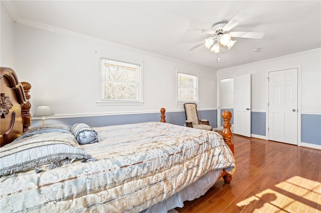 bedroom with ceiling fan, hardwood / wood-style floors, and ornamental molding