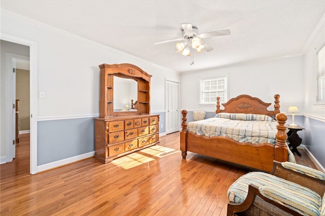 bedroom with ceiling fan, a closet, multiple windows, and ornamental molding