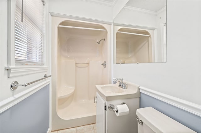 bathroom featuring toilet, vanity, a shower, and ornamental molding