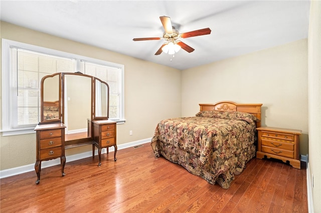 bedroom with ceiling fan and hardwood / wood-style flooring