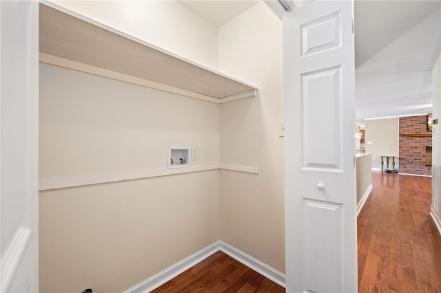 clothes washing area with hardwood / wood-style flooring, washer hookup, and a fireplace