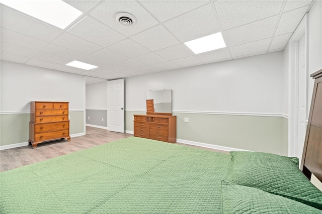 unfurnished bedroom featuring light hardwood / wood-style floors and a paneled ceiling