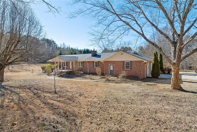 single story home with a front yard and a porch