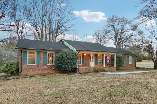 ranch-style home featuring a front yard and a porch