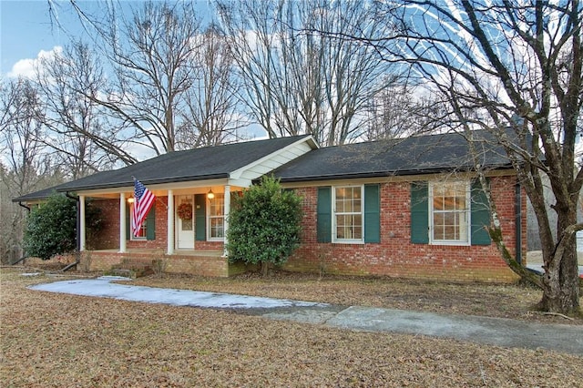 single story home featuring covered porch