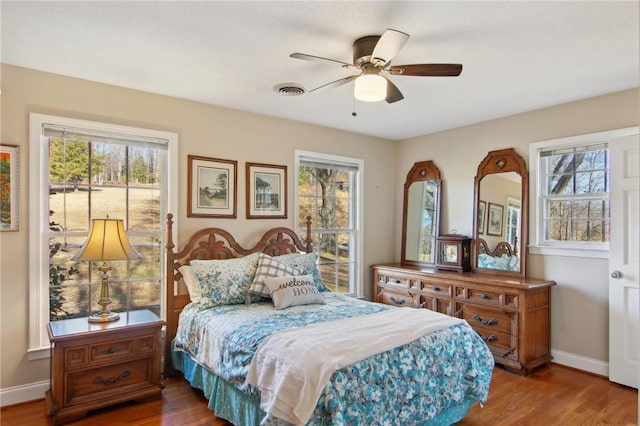 bedroom with ceiling fan and hardwood / wood-style flooring